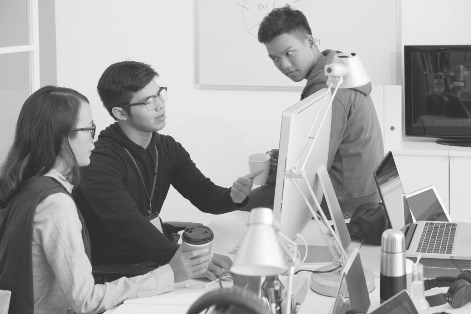 Developer working on blockchain code with multiple monitors showing smart contract development